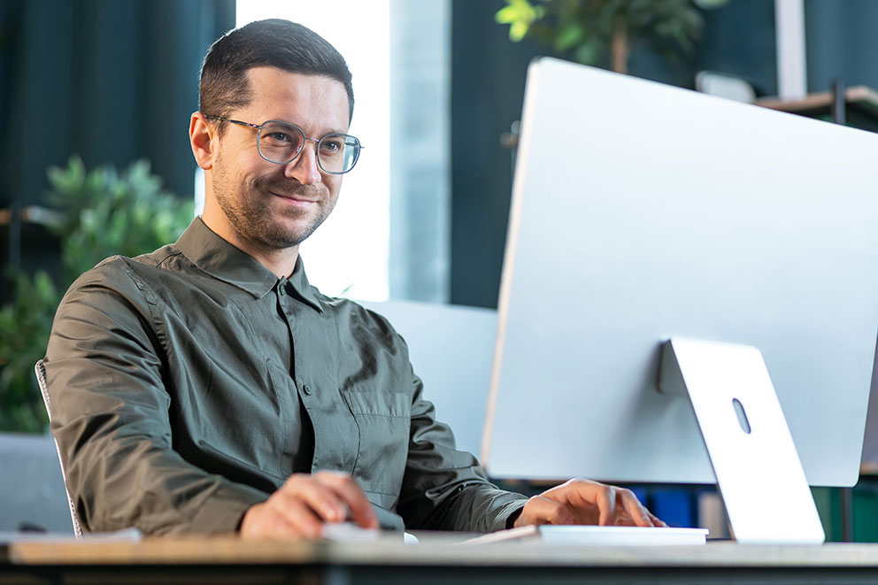Verwaltungsmitarbeiter sitzend am Computer